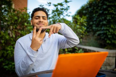 VT student holding up his fingers to represent VT